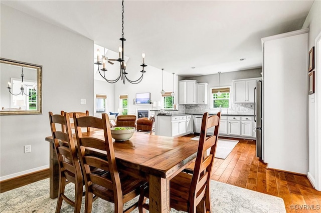 10527 Deerlake Dr, New Kent, VA 23124 - dining room featuring a chandelier, wood-type flooring, and baseboards