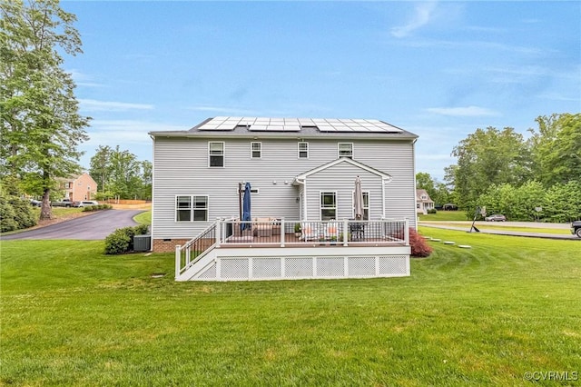 10527 Deerlake Dr, New Kent, VA 23124 - rear view of house with a wooden deck, a lawn, central air condition unit, and solar panels