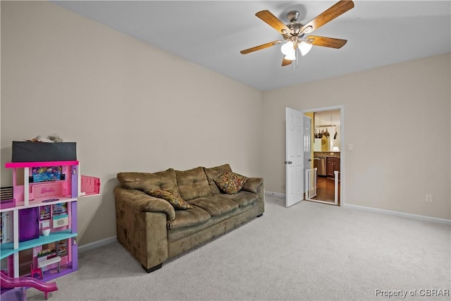 living room with carpet, a ceiling fan, and baseboards