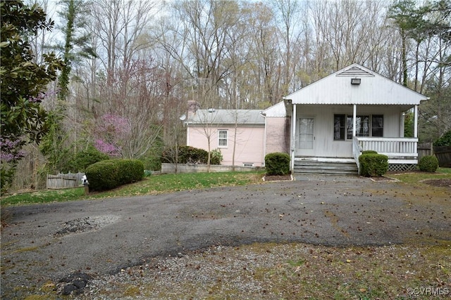 bungalow-style home with a porch and a chimney