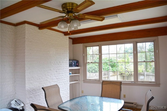 dining area with beamed ceiling, a baseboard heating unit, plenty of natural light, and a ceiling fan