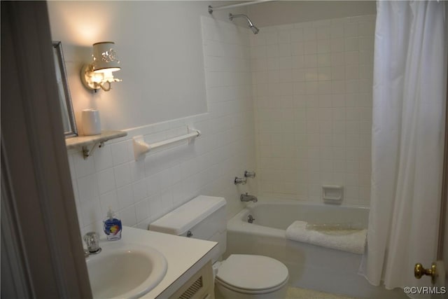 full bathroom with tile walls, shower / bath combination with curtain, toilet, and vanity