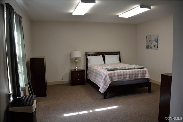 bedroom featuring carpet flooring and baseboards
