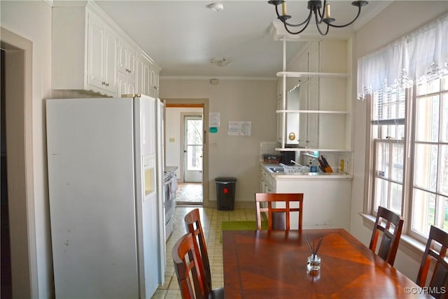 dining area with a chandelier, crown molding, and baseboards