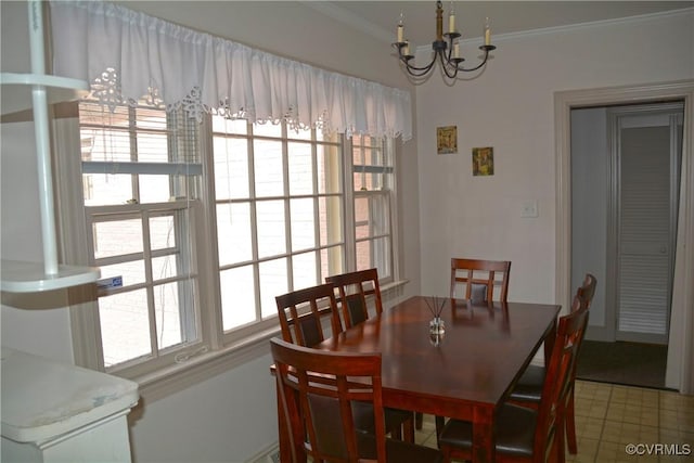 dining area featuring a chandelier, ornamental molding, and healthy amount of natural light