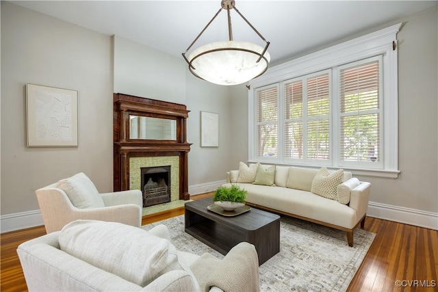 2706 W Grace St, Richmond, VA 23220 - living area with baseboards, wood finished floors, and a stone fireplace