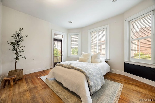 2706 W Grace St, Richmond, VA 23220 - bedroom featuring multiple windows, baseboards, and hardwood / wood-style flooring