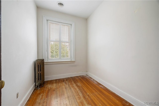 2706 W Grace St, Richmond, VA 23220 - unfurnished room featuring radiator, light wood finished floors, and baseboards