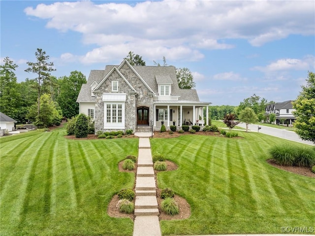 16306 Fleetwood Rd, Midlothian, VA 23112 - view of front of house with stone siding, a front lawn, covered porch, and a standing seam roof