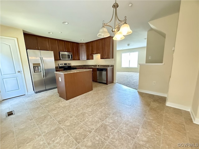 3000 Perdue Springs Ln, Chester, VA 23831 - kitchen featuring stainless steel appliances, a center island, baseboards, a chandelier, and a sink