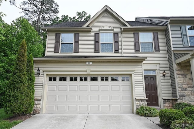 5801 Riverside Trl, Richmond, VA 23225 - view of front of house featuring a garage, driveway, and stone siding
