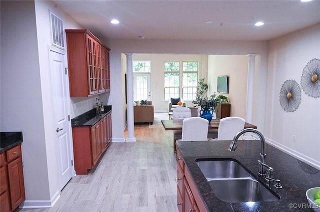 5801 Riverside Trl, Richmond, VA 23225 - kitchen featuring ornate columns, a sink, reddish brown cabinets, light wood-style floors, and recessed lighting