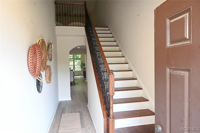 5801 Riverside Trl, Richmond, VA 23225 - staircase with arched walkways, wood finished floors, a high ceiling, and baseboards