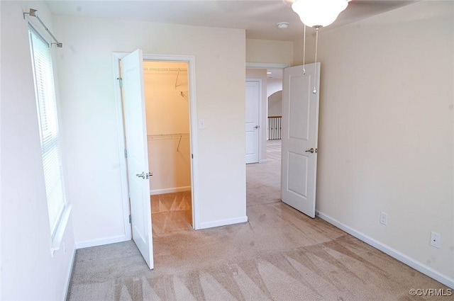 5801 Riverside Trl, Richmond, VA 23225 - unfurnished bedroom featuring a spacious closet, carpet, a closet, baseboards, and arched walkways