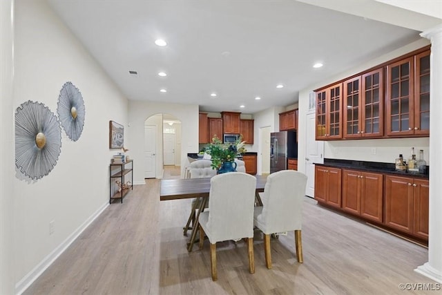 5801 Riverside Trl, Richmond, VA 23225 - dining area featuring arched walkways, light wood-style flooring, recessed lighting, and baseboards