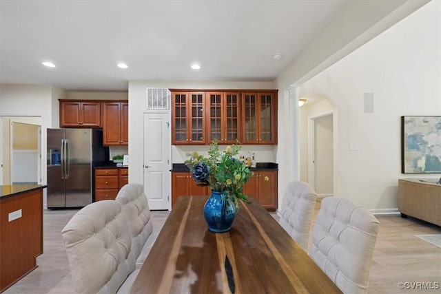 5801 Riverside Trl, Richmond, VA 23225 - dining room featuring arched walkways, recessed lighting, light wood-style floors, and baseboards