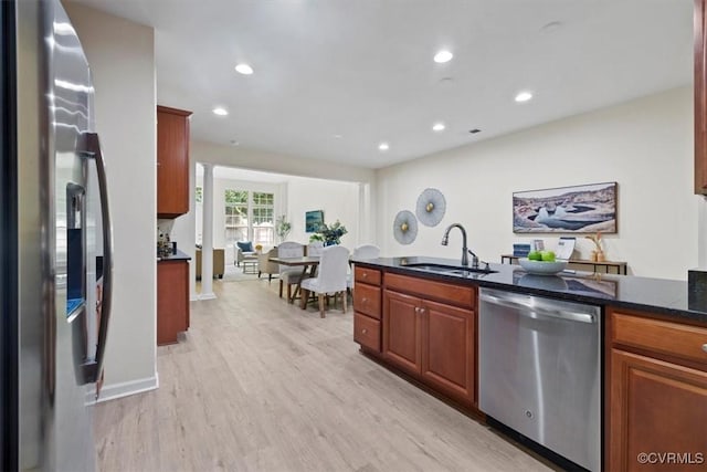 5801 Riverside Trl, Richmond, VA 23225 - kitchen featuring appliances with stainless steel finishes, a sink, light wood-style floors, recessed lighting, and dark stone counters