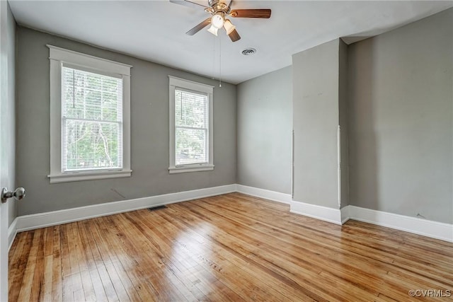unfurnished room featuring baseboards, light wood-type flooring, and ceiling fan