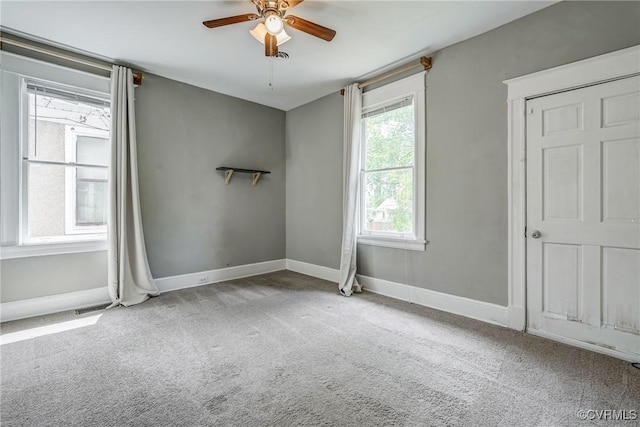 unfurnished bedroom featuring carpet floors, baseboards, and a ceiling fan