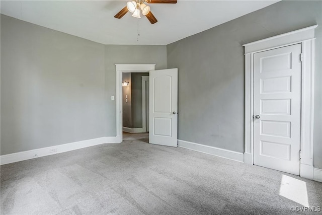 unfurnished bedroom featuring carpet, baseboards, and ceiling fan