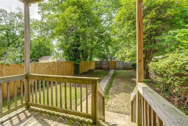 wooden deck with a fenced backyard