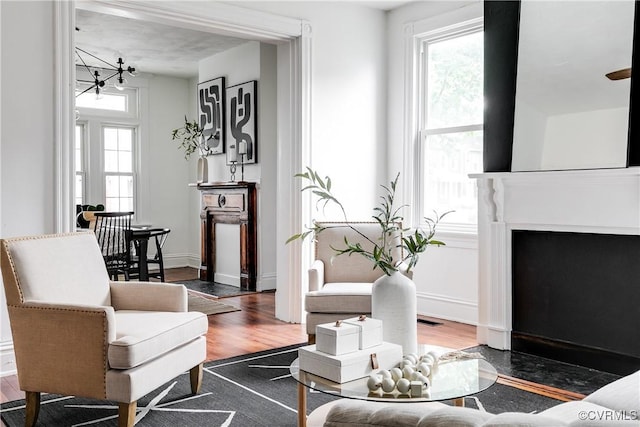 1517 Oakwood Ave, Richmond, VA 23223 - living room with wood finished floors, a fireplace with flush hearth, and baseboards