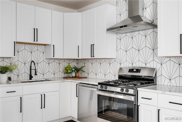 1517 Oakwood Ave, Richmond, VA 23223 - kitchen featuring appliances with stainless steel finishes, ventilation hood, a sink, light countertops, and backsplash