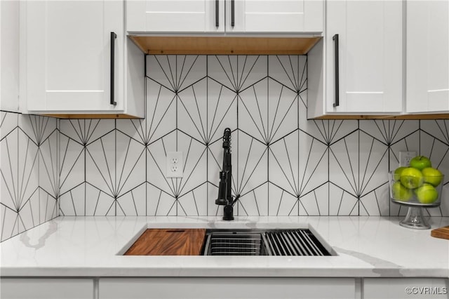 1517 Oakwood Ave, Richmond, VA 23223 - kitchen view of tasteful backsplash, white cabinetry, and a sink