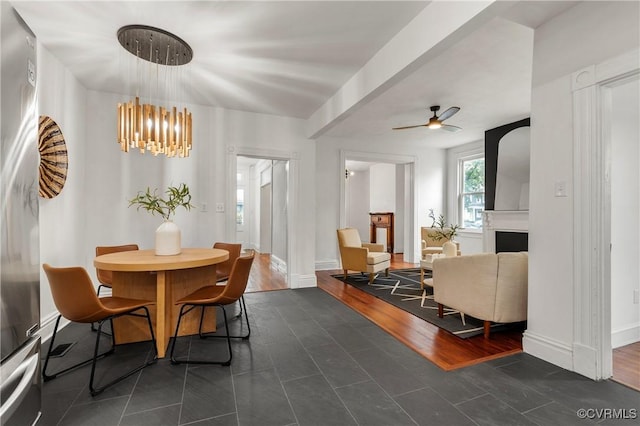 1517 Oakwood Ave, Richmond, VA 23223 - dining area featuring a chandelier, a fireplace, a ceiling fan, and baseboards