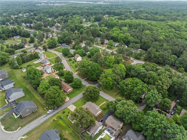 aerial perspective of suburban area featuring a heavily wooded area