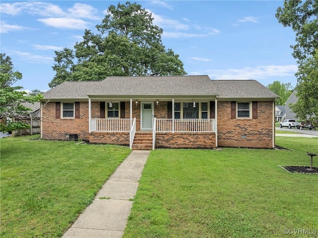 single story home featuring a porch, a front yard, and brick siding