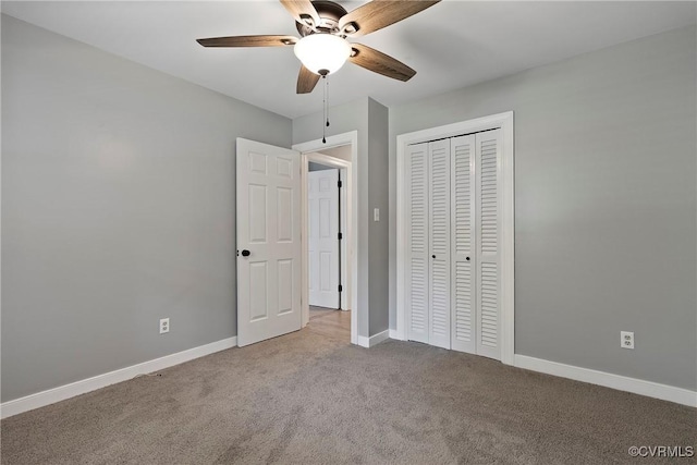unfurnished bedroom featuring carpet, baseboards, a closet, and ceiling fan