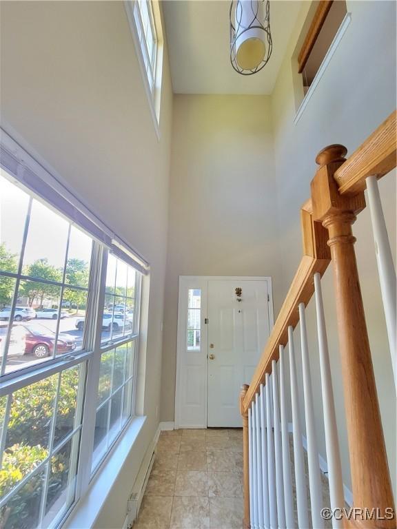 entrance foyer with a high ceiling and light tile patterned floors