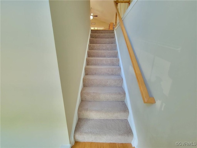 staircase featuring baseboards