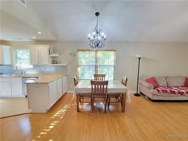 dining room featuring light wood-type flooring, a chandelier, recessed lighting, and baseboards