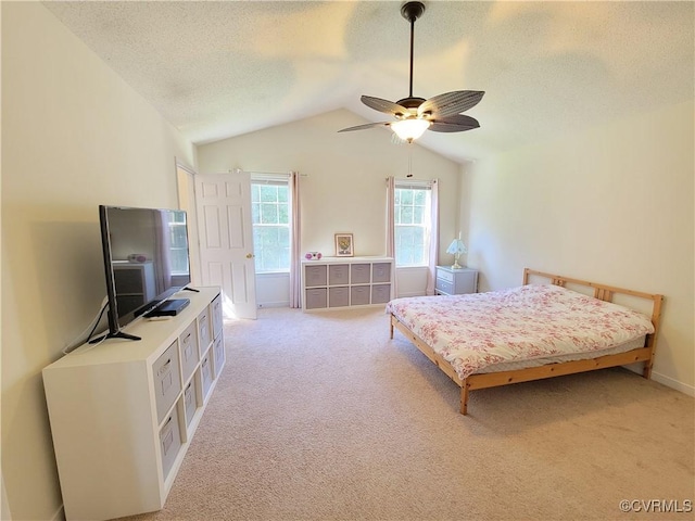 bedroom with light carpet, a textured ceiling, lofted ceiling, ceiling fan, and baseboards