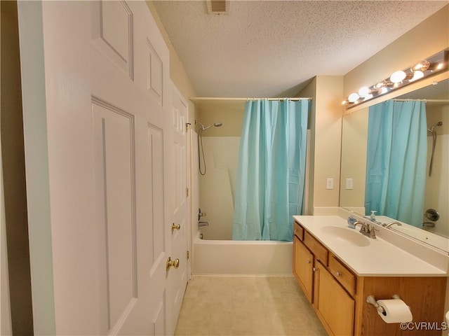 full bathroom with a textured ceiling, shower / bath combination with curtain, and vanity