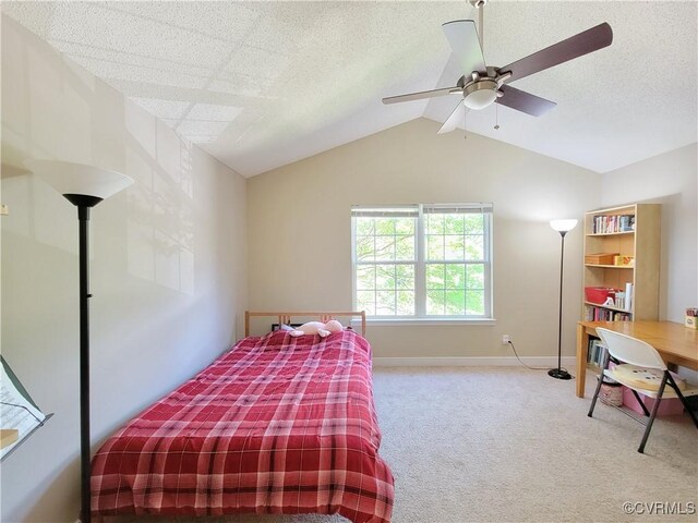 bedroom with carpet floors, vaulted ceiling, baseboards, and a ceiling fan