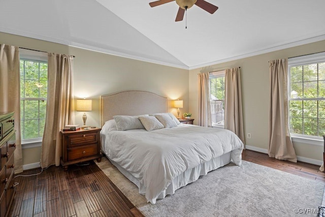 bedroom featuring vaulted ceiling, wood finished floors, baseboards, ceiling fan, and crown molding