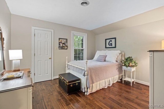 bedroom featuring dark wood-style floors, vaulted ceiling, and baseboards