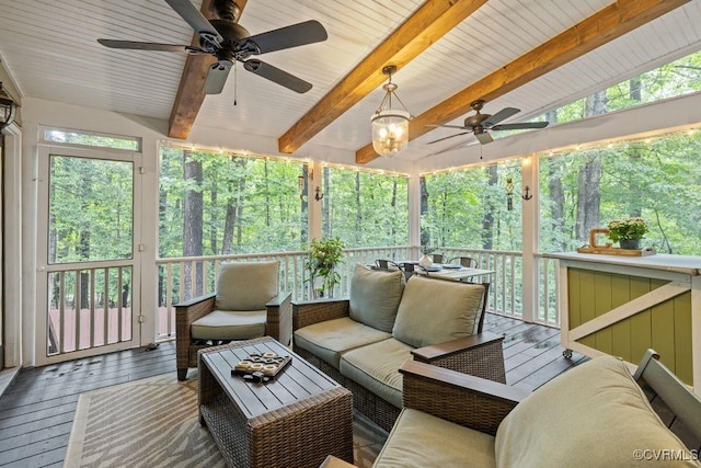 sunroom / solarium with ceiling fan, an outdoor living space, and beam ceiling