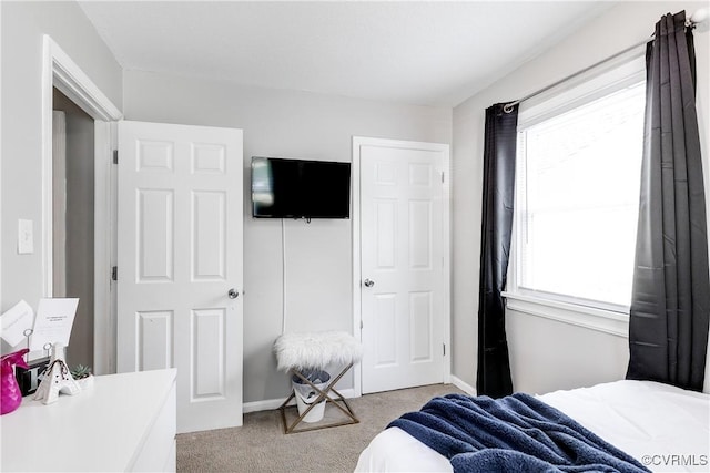 bedroom with carpet and baseboards