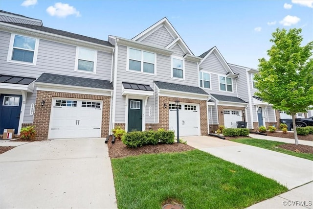 11301 Winding Brook Terrace Dr, Hanover, VA 23005 - townhome / multi-family property featuring brick siding, concrete driveway, a garage, and a front lawn