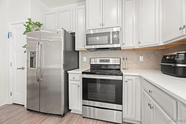 11301 Winding Brook Terrace Dr, Hanover, VA 23005 - kitchen with stainless steel appliances, light countertops, light wood finished floors, backsplash, and white cabinets