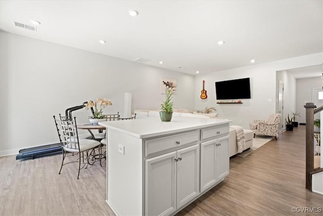 11301 Winding Brook Terrace Dr, Hanover, VA 23005 - kitchen featuring light wood finished floors, a kitchen island, recessed lighting, open floor plan, and light countertops