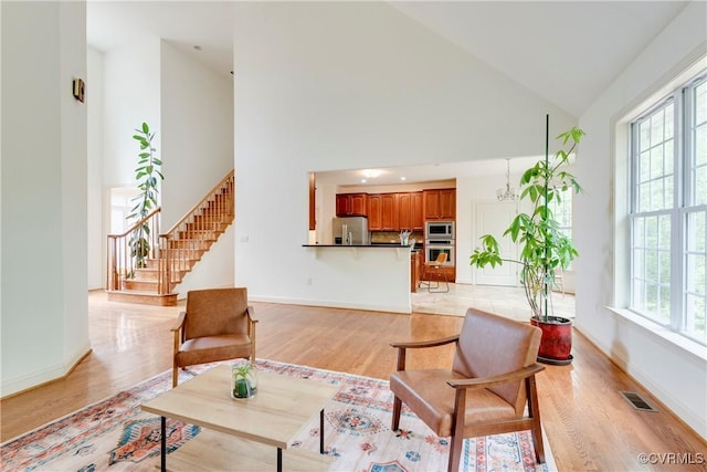 5470 Tyshire Pkwy, Providence Forge, VA 23140 - living area with healthy amount of natural light, high vaulted ceiling, baseboards, and light wood-type flooring