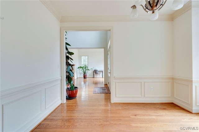 5470 Tyshire Pkwy, Providence Forge, VA 23140 - hallway featuring a wainscoted wall, light wood finished floors, ornamental molding, and a decorative wall