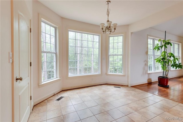 5470 Tyshire Pkwy, Providence Forge, VA 23140 - unfurnished dining area with healthy amount of natural light, light tile patterned flooring, a chandelier, and baseboards