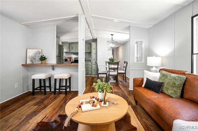 living room featuring dark wood-type flooring and a chandelier