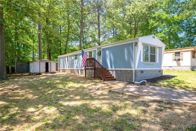 manufactured / mobile home featuring crawl space, a storage shed, and an outbuilding